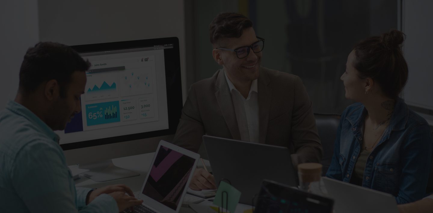 Three People in A Marketing Team Discussing Something in An Office Setting.