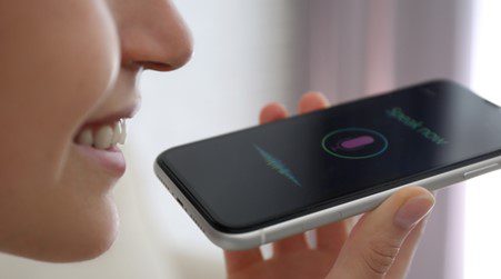 Woman using voice assistant on her phone.