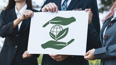 Business team with green globe and plant.