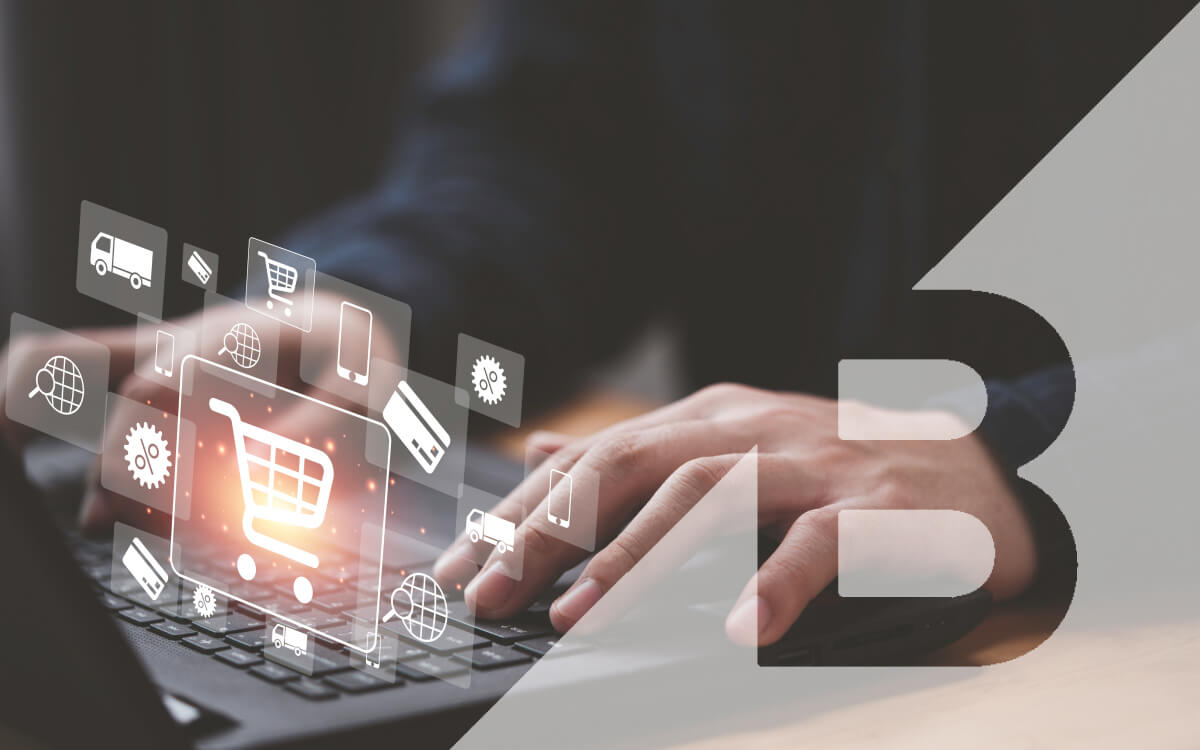 A Person Using a Laptop With Ecommerce-Related Graphic Icons Floating Above the Keyboard Along with the Bigcommerce Logo.
