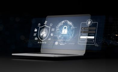 A Modern Laptop Open on a Desk Displaying Graphics Related to Cybersecurity.