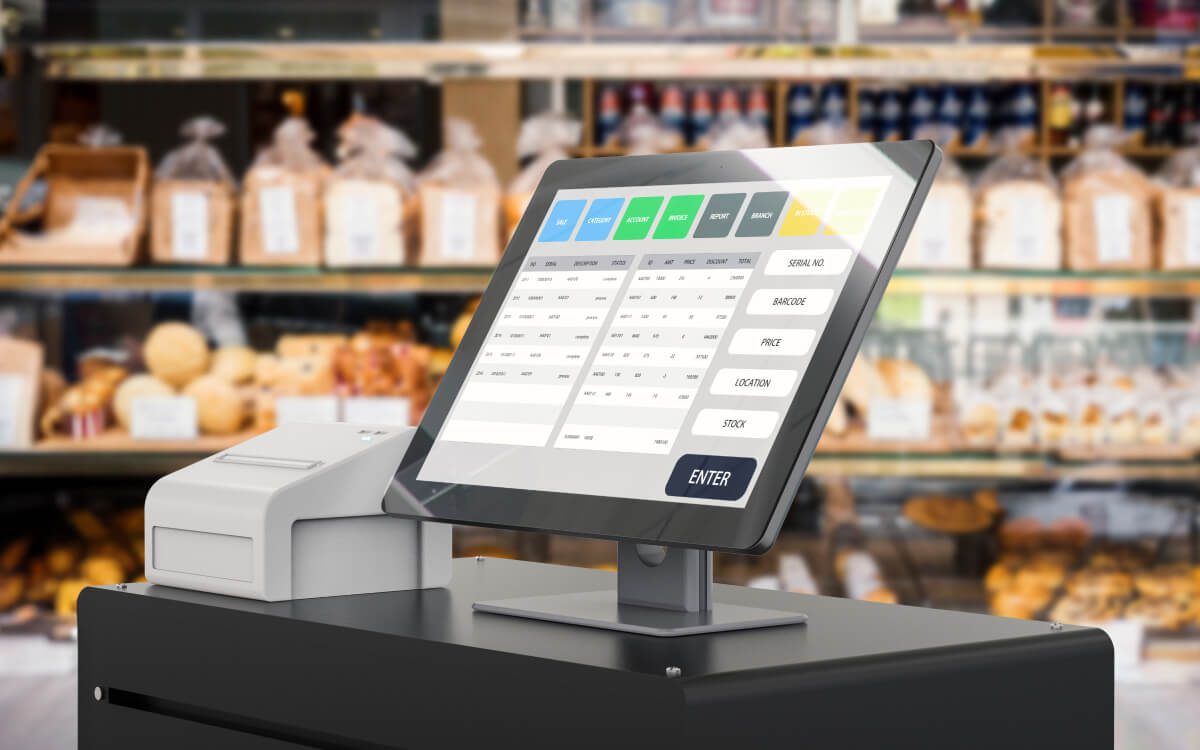 A Modern Point of Sale (POS) System With a Touchscreen Display Showing Various Buttons Such as 'Bread', 'Cheese,' 'Snacks,' and Other Categories in a Bakery Setting.