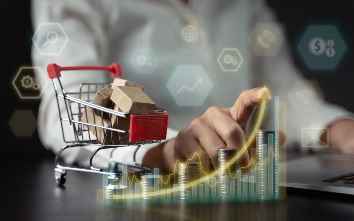 A Person in a White Shirt Interacts With a Digital Interface & A Miniature Shopping Cart Showing Rising and Falling Bar Graphs.