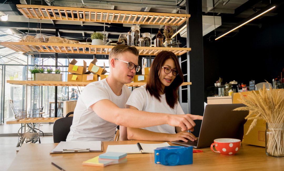 Two professionals working on custom ecommerce website design.