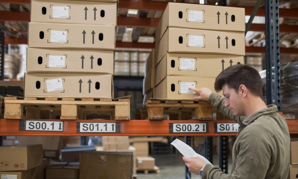 A person checking stock inventory in the warehouse