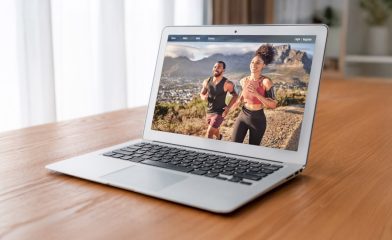 A laptop displays an image of two individuals involved in health and wellness eCommerce