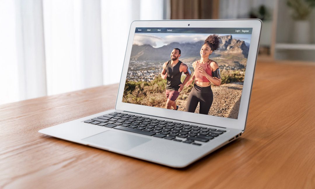 A laptop displays an image of two individuals involved in health and wellness eCommerce