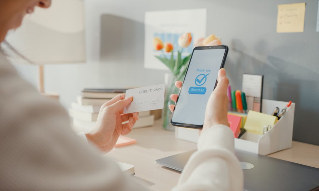 Women use smartphones for quick and easy credit card balance checks, thanks to Helium customer fields' efficient checkout process.