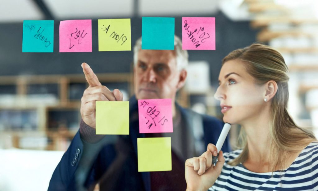 Team members engage in project planning using sticky notes for organization.