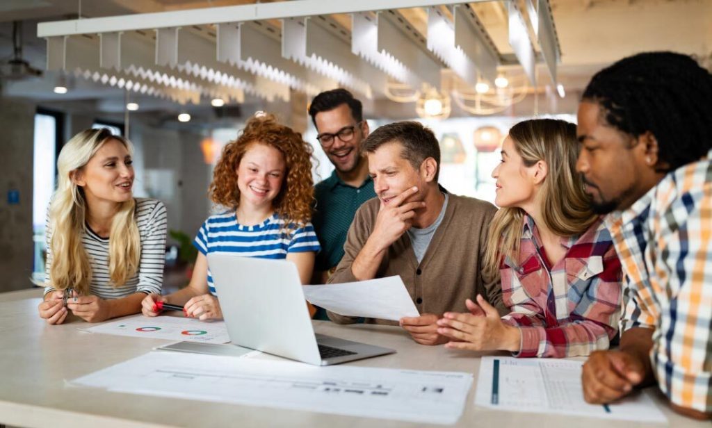 Team in a collaborative office meeting and discussing B2B website development strategies.