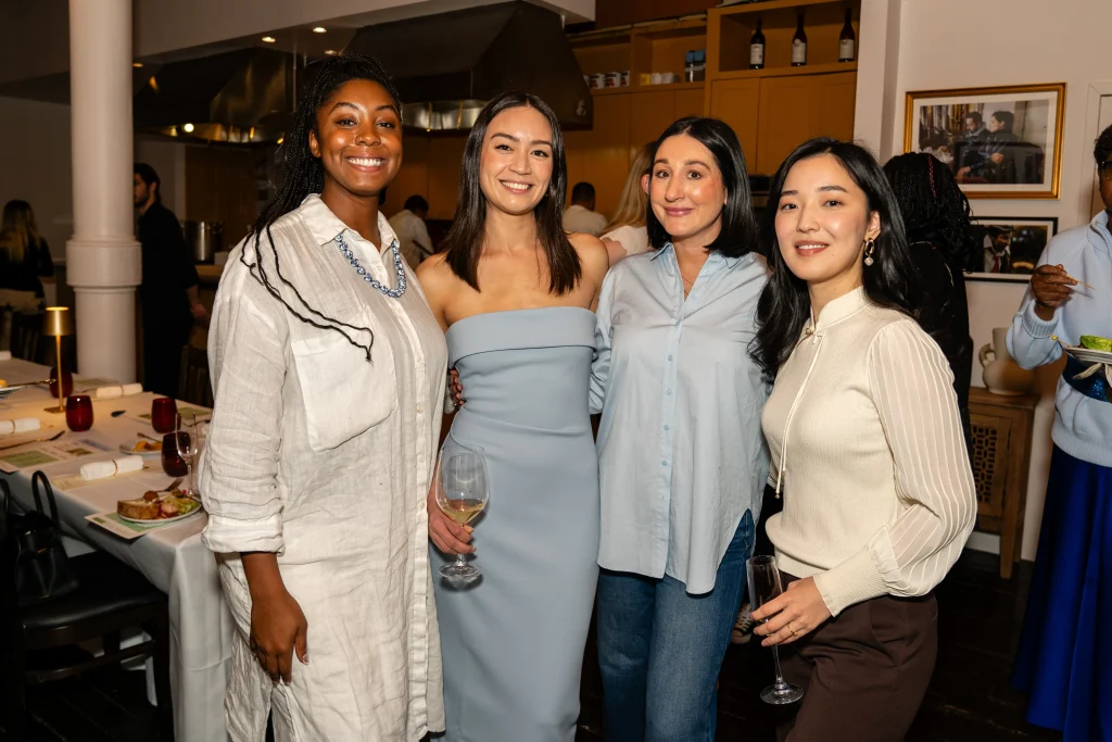 Cassandra Cross and Nicole Harvey, pictured center, during the HSGH dinner party alongside fellow women leaders.